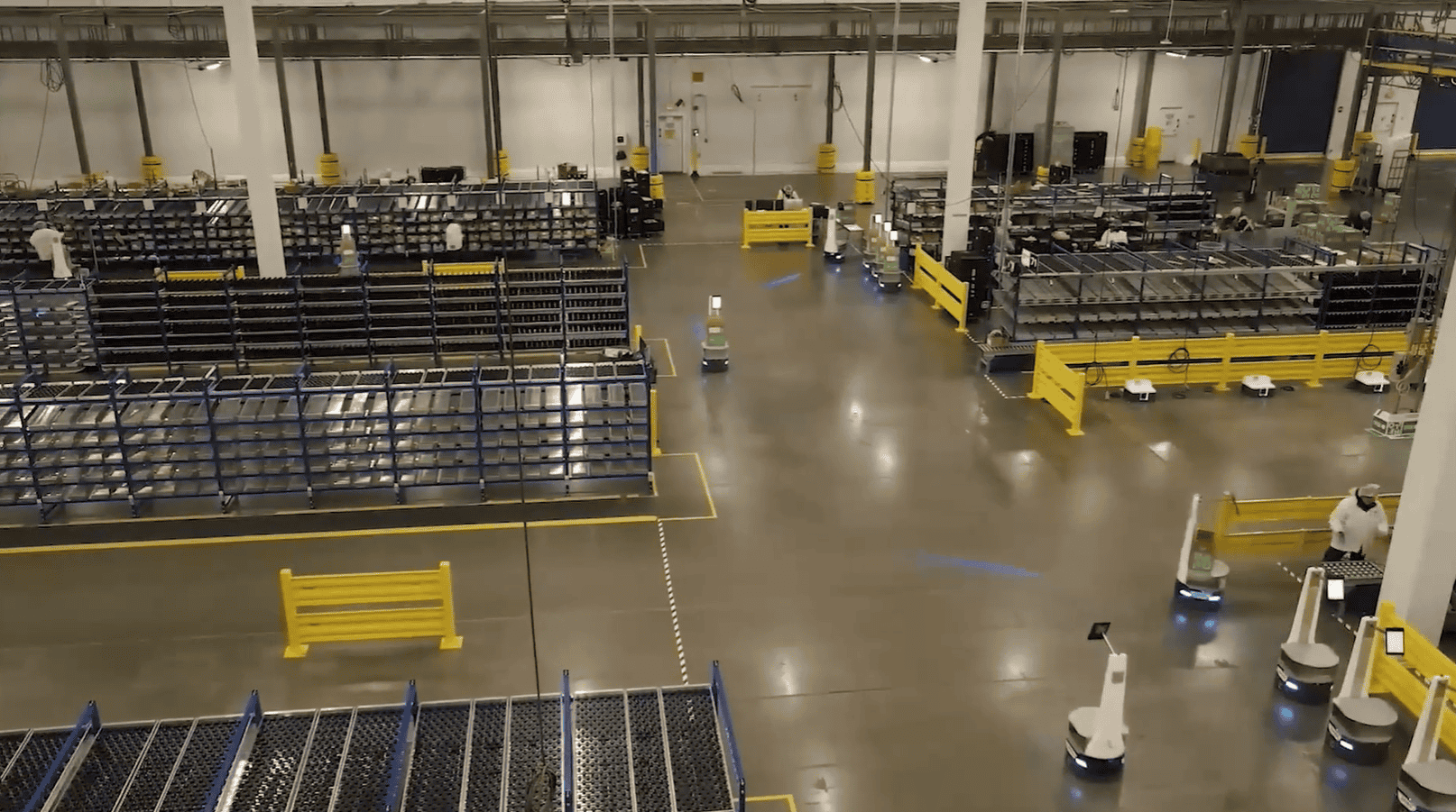 Autonomous mobile robots transporting products inside a refrigerated HelloFresh warehouse fulfilment centre.